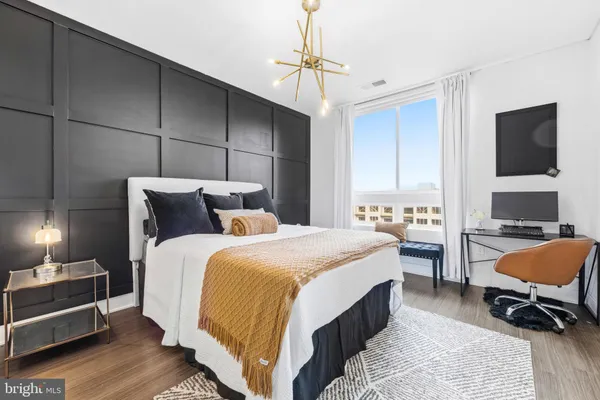 a bedroom with a bed a desk and chair