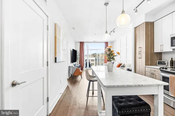 a kitchen with stainless steel appliances a stove a table and chairs