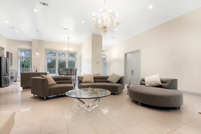 a living room with furniture and a chandelier
