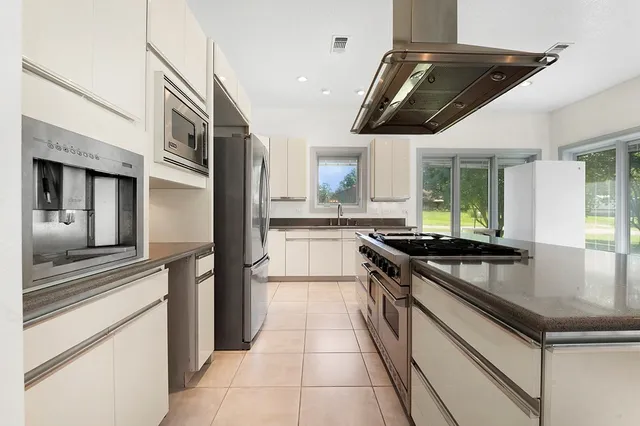 a kitchen with stainless steel appliances granite countertop a stove and a sink
