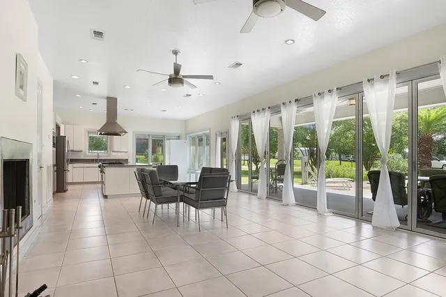 a dining room with furniture a chandelier and fireplace