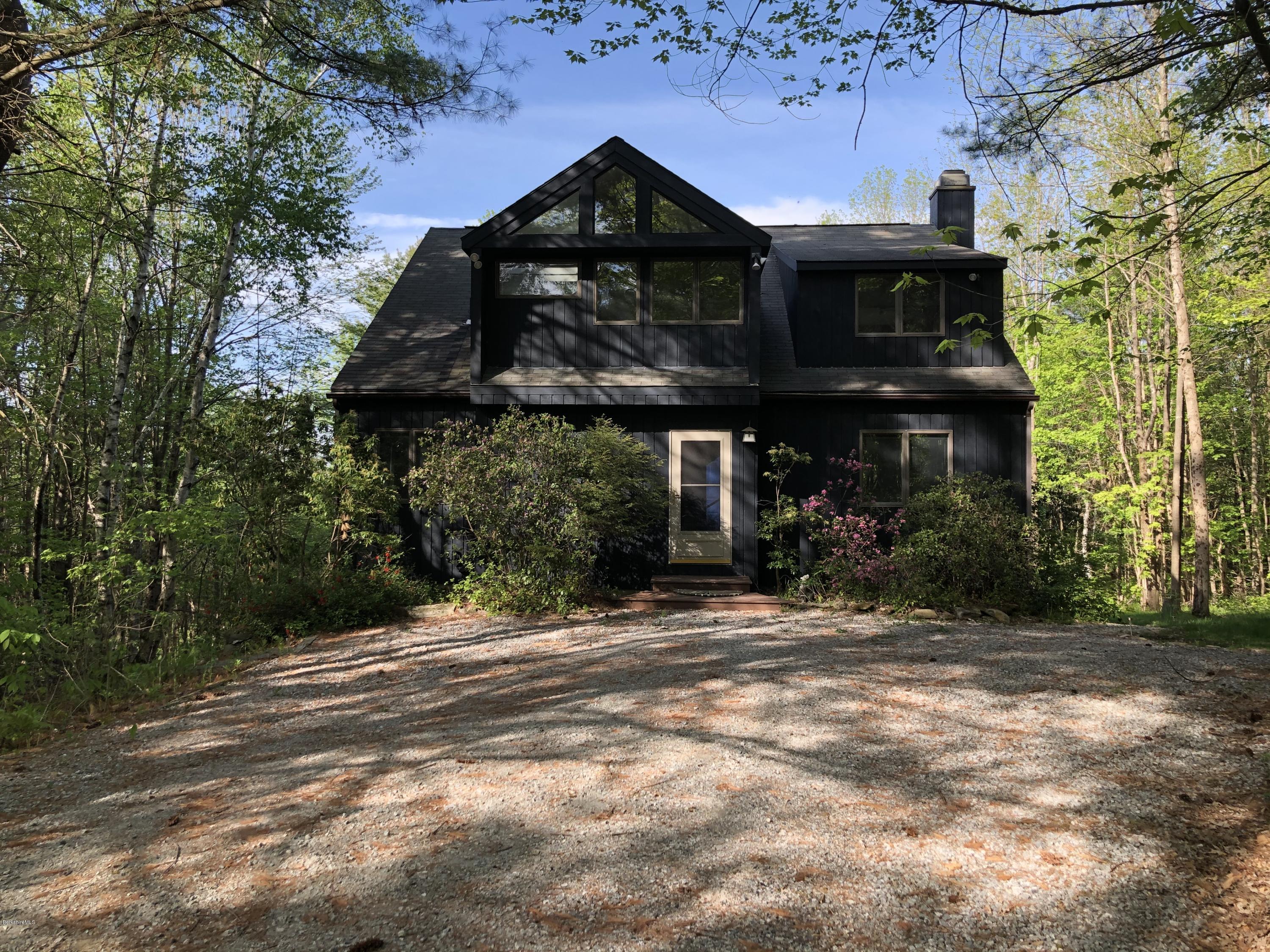 167 Bonny Rigg Hill Road Becket, MA 01223 - Photo 3 of 44 a front view of a house with a garden