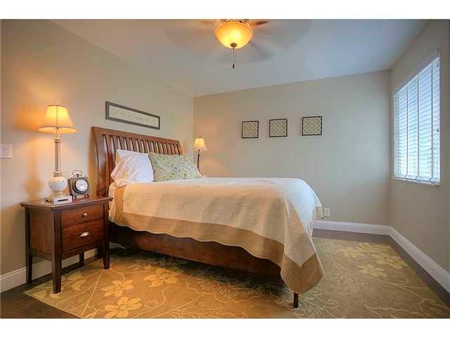 2563 Southeast Springtree Place Stuart, FL 34997 - Photo 13 of 20 a bed sitting in a bedroom next to a window