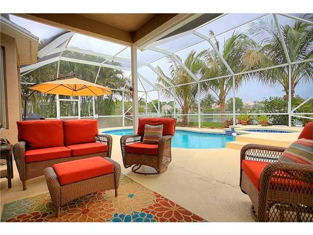 2563 Southeast Springtree Place Stuart, FL 34997 - Photo 17 of 20 a backyard of a house with a table and chairs