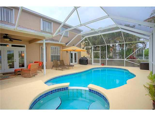 2563 Southeast Springtree Place Stuart, FL 34997 - Photo 18 of 20 a swimming pool with outdoor seating and yard