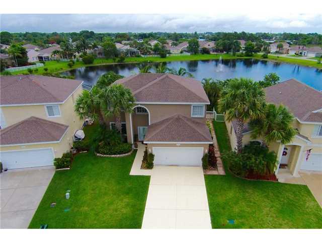 2563 Southeast Springtree Place Stuart, FL 34997 - Photo 2 of 20 a aerial view of a house with garden and lake view
