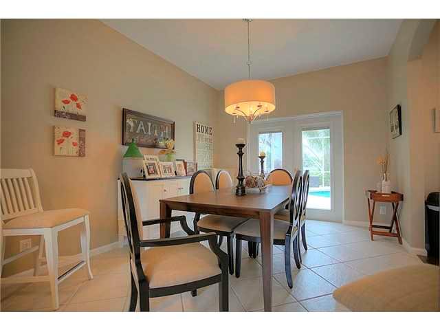 2563 Southeast Springtree Place Stuart, FL 34997 - Photo 6 of 20 a view of a dining room with furniture and chandelier