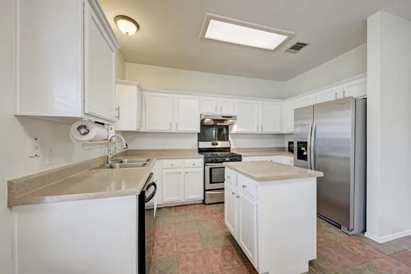 a kitchen with a sink stove and refrigerator