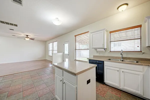 a kitchen with a sink cabinets and window