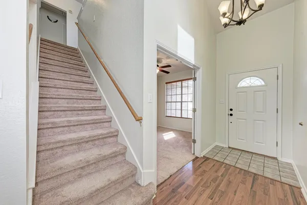 a view of entryway and hall with wooden floor