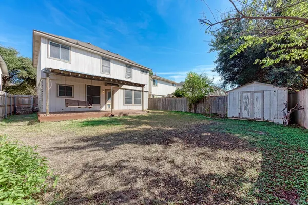 a view of a house with a backyard