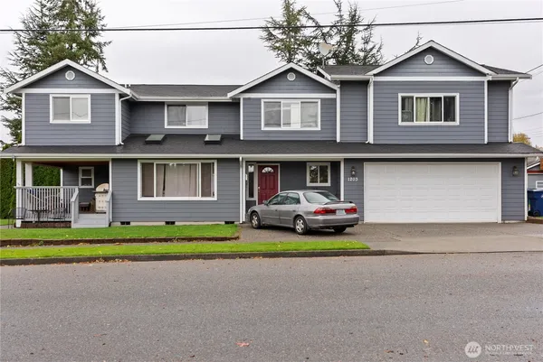 a front view of a house with a yard and garage