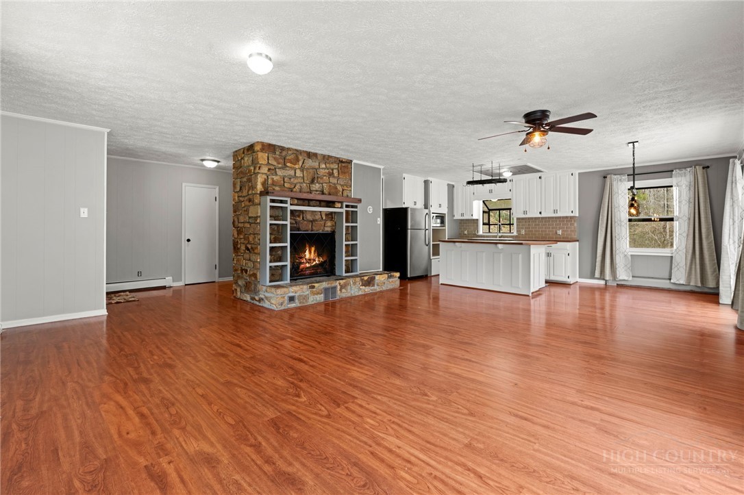 2345 Watauga River Road Sugar Grove, NC 28679 - Photo 8 of 50 a view of a livingroom with furniture wooden floor and a kitchen