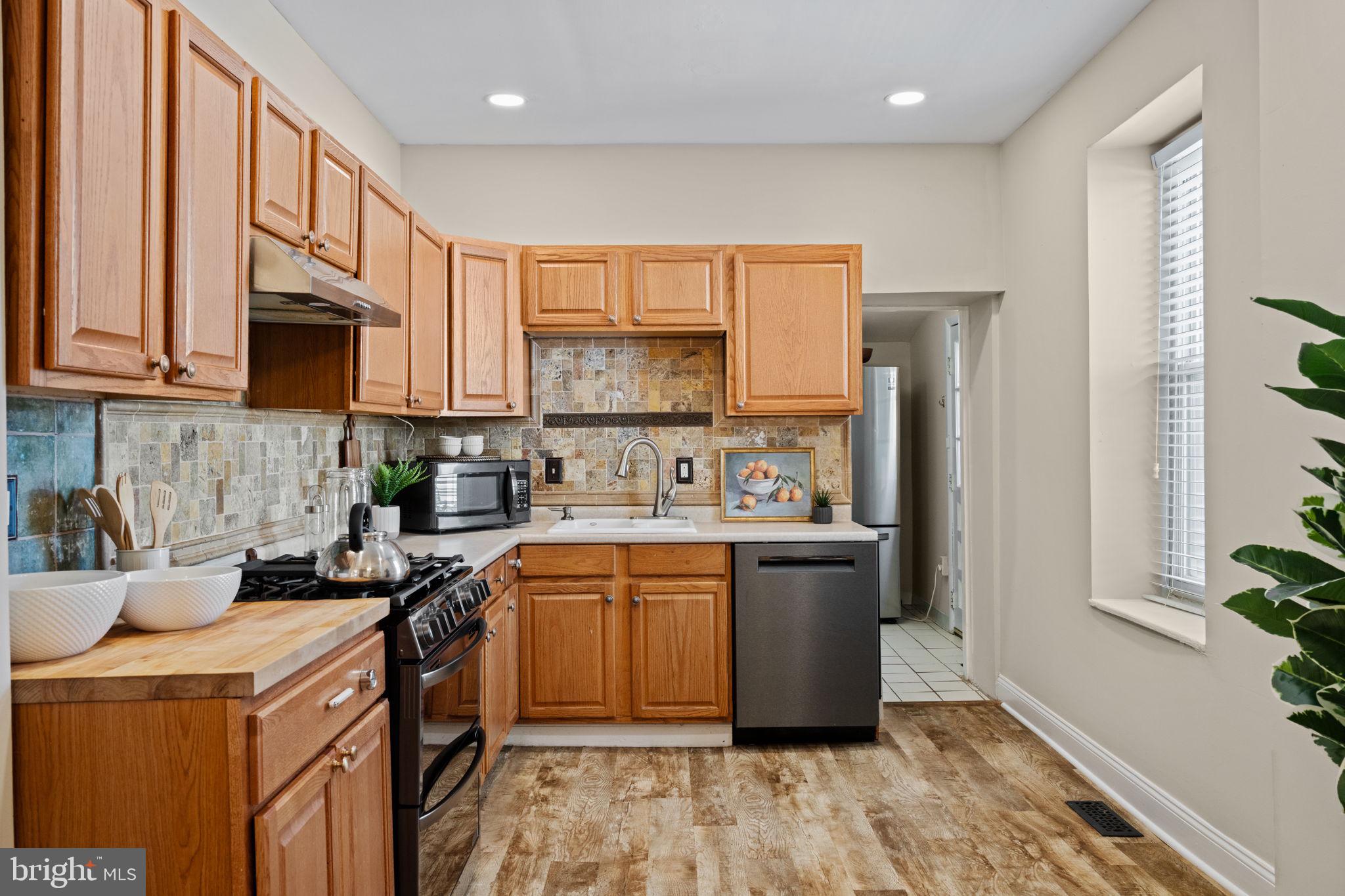 4092 Pechin Street Philadelphia, PA 19128 - Photo 8 of 28 a kitchen with stainless steel appliances granite countertop a stove a sink a refrigerator and a microwave