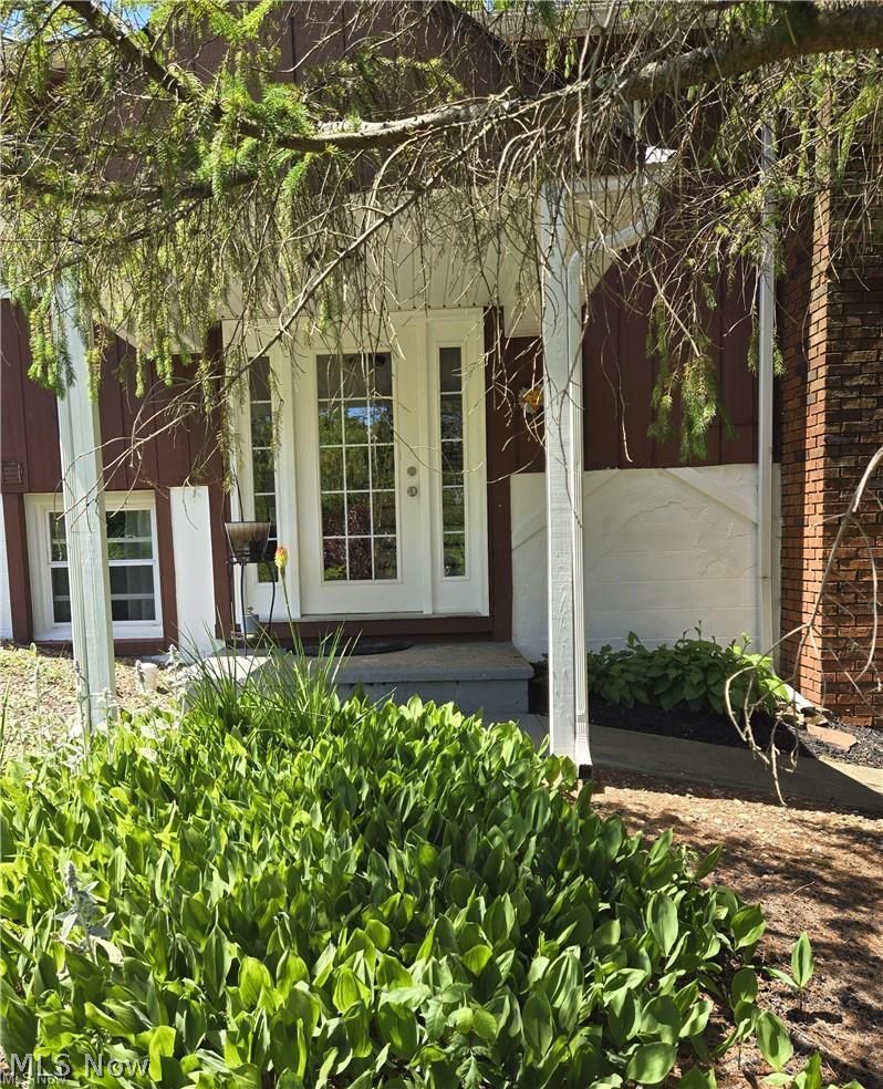 14640 Stone Road Newbury, OH 44065 - Photo 2 of 19 The front door is shaded by towering pines