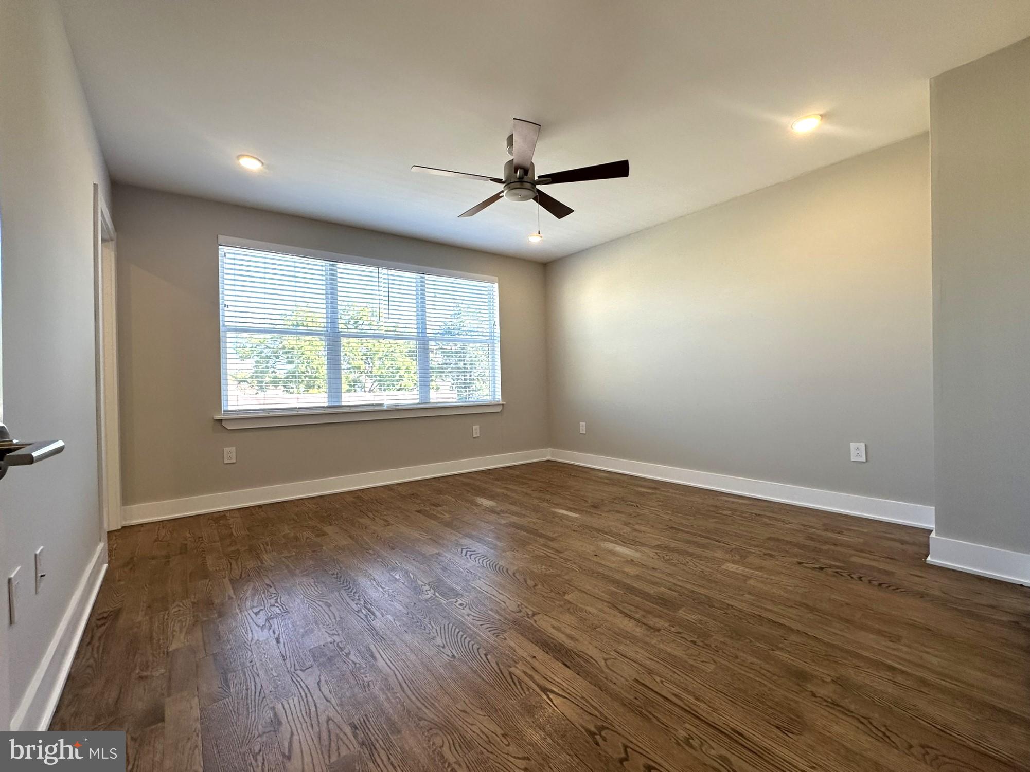 963 Shackamaxon Street, Unit 4 Philadelphia, PA 19125 - Photo 18 of 35 an empty room with wooden floor ceiling fan and windows