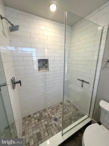 a bathroom with a sink toilet and mirror