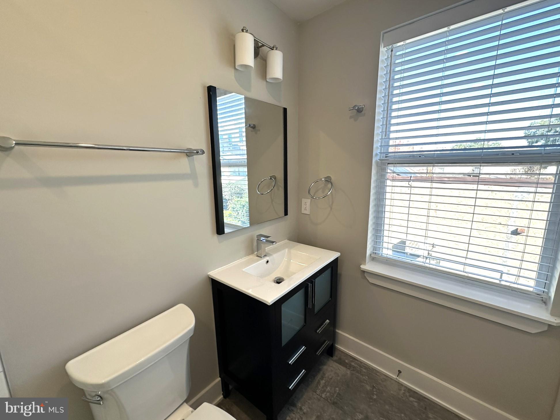 963 Shackamaxon Street, Unit 4 Philadelphia, PA 19125 - Photo 24 of 35 a bathroom with a sink toilet and mirror