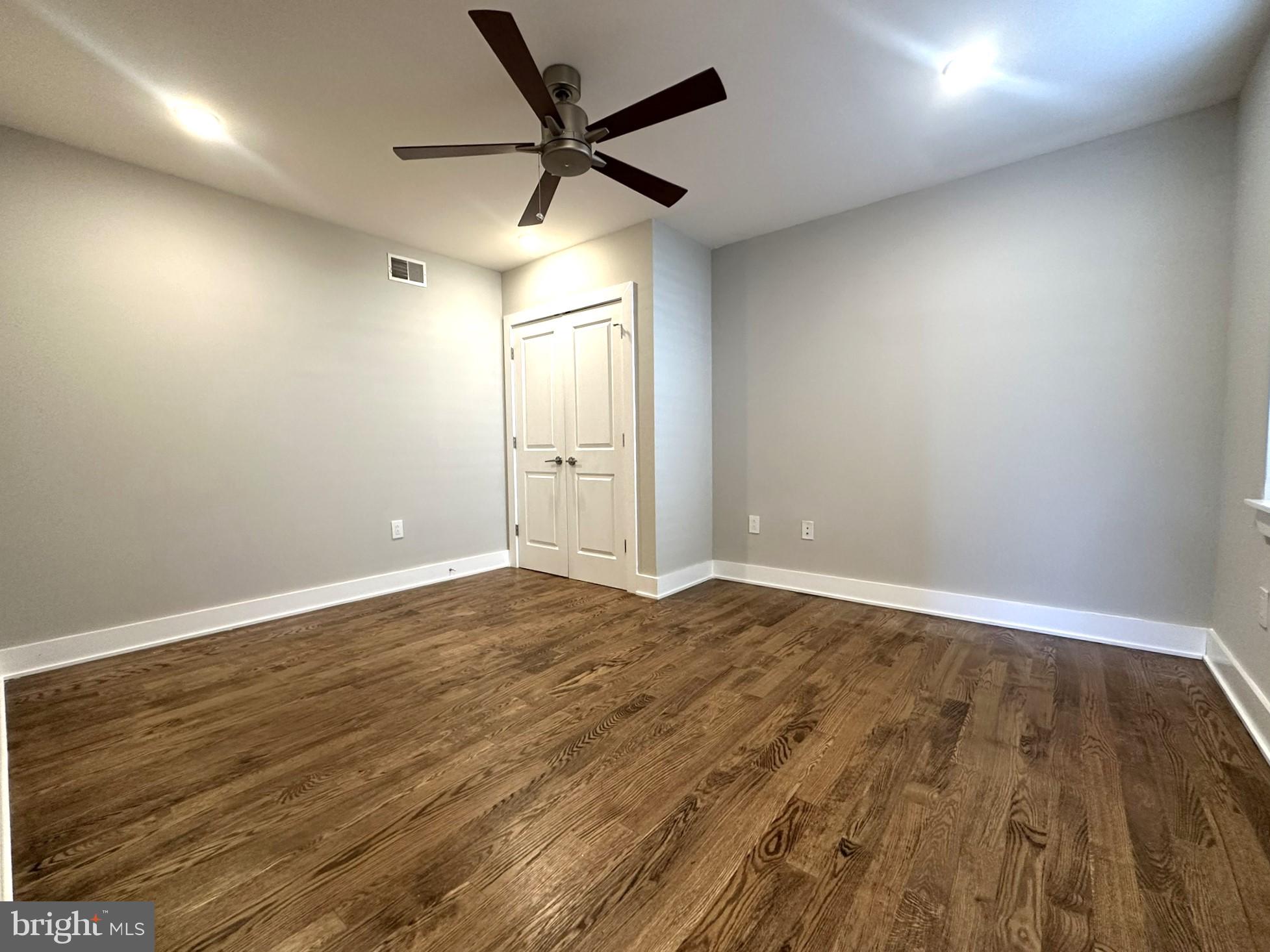 963 Shackamaxon Street, Unit 4 Philadelphia, PA 19125 - Photo 26 of 35 an empty room with wooden floor and windows