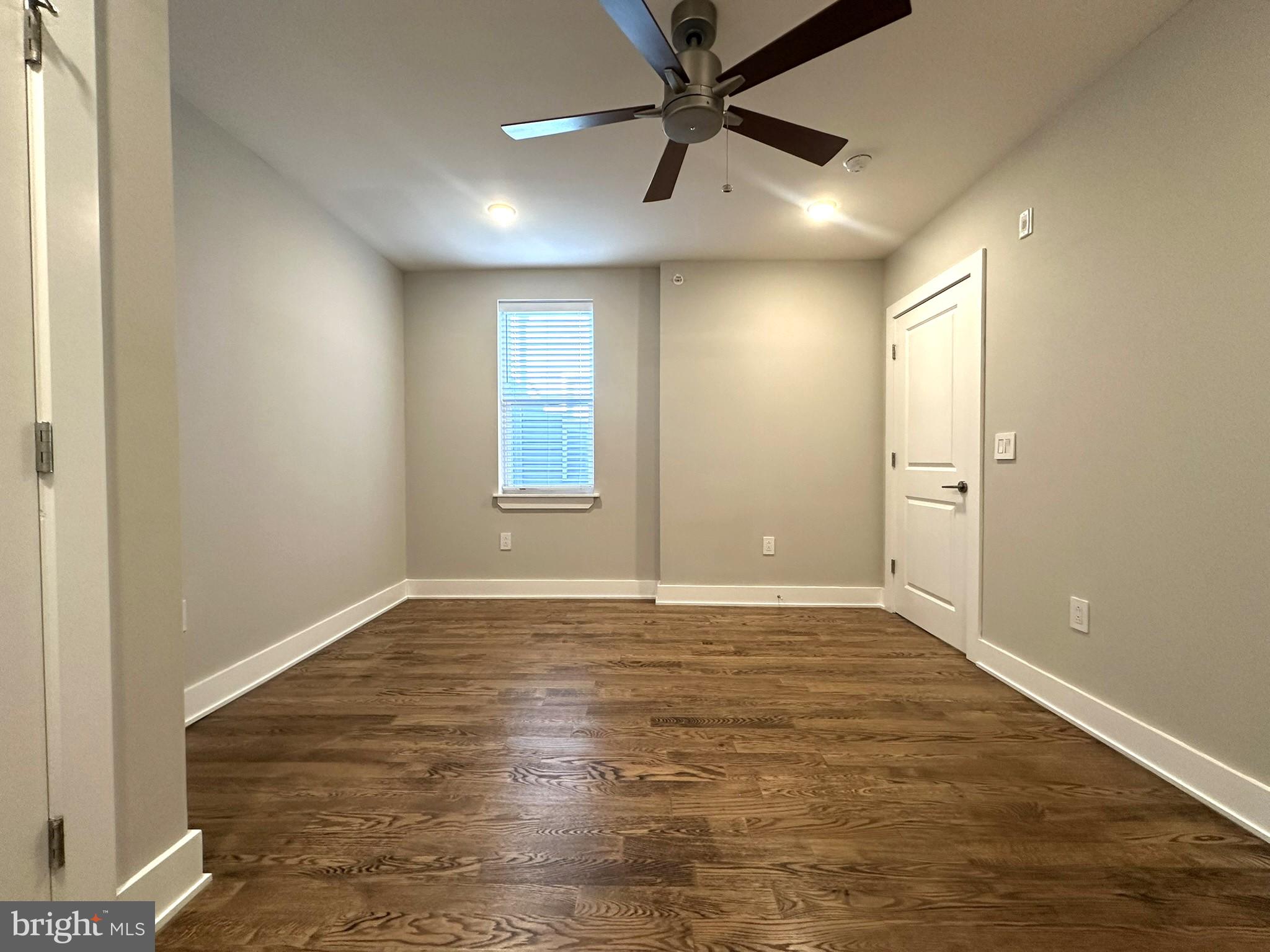 963 Shackamaxon Street, Unit 4 Philadelphia, PA 19125 - Photo 28 of 35 an empty room with wooden floor and windows