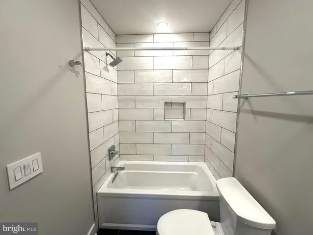 a white toilet sitting next to a bathroom sink