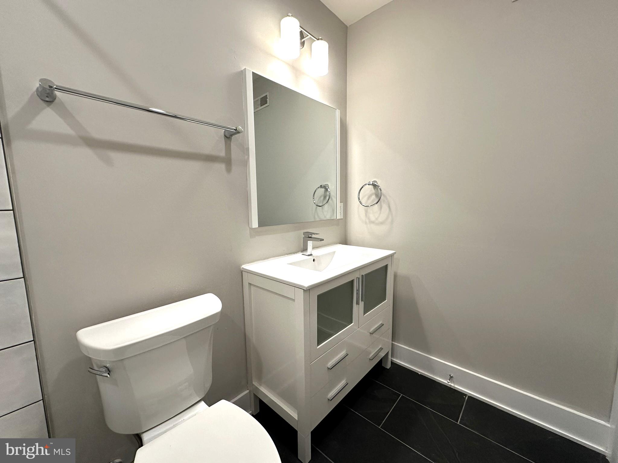 963 Shackamaxon Street, Unit 4 Philadelphia, PA 19125 - Photo 32 of 35 a white toilet sitting next to a bathroom sink