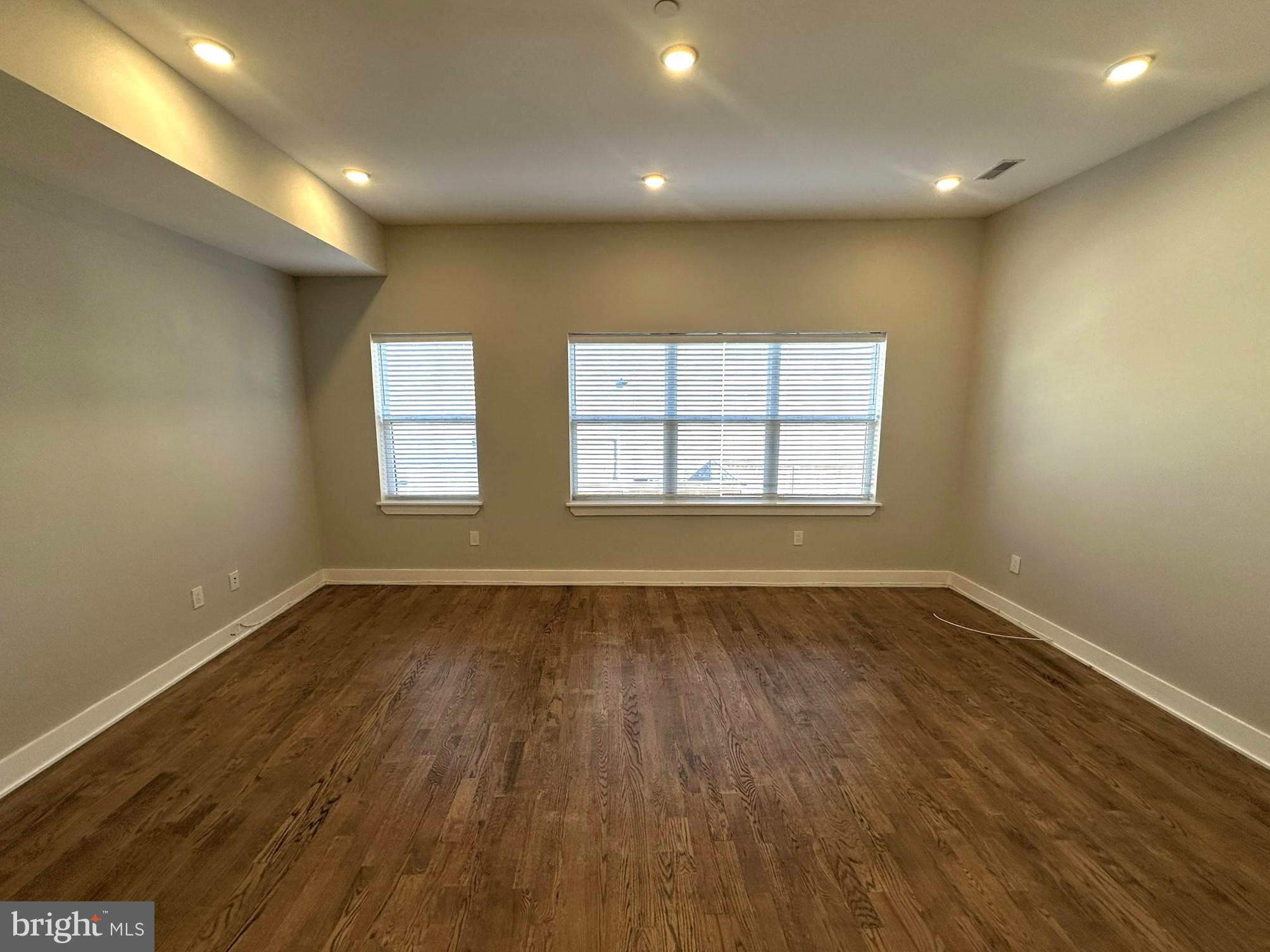 963 Shackamaxon Street, Unit 4 Philadelphia, PA 19125 - Photo 6 of 35 an empty room with wooden floor and windows