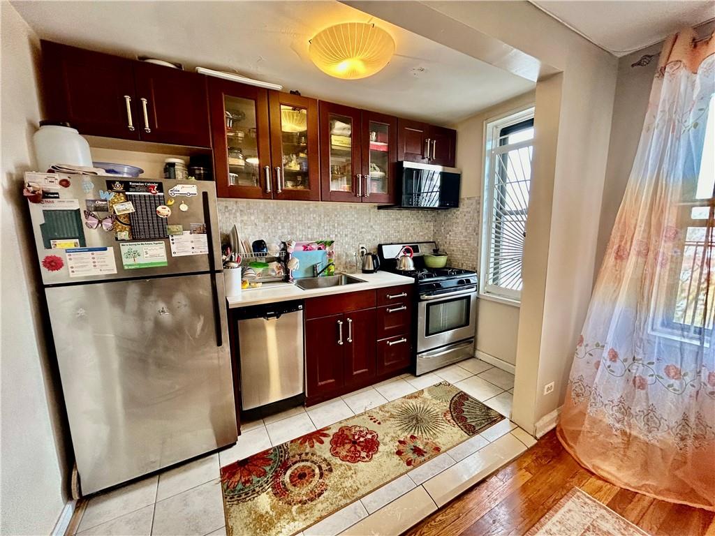 a kitchen with stainless steel appliances granite countertop a refrigerator stove and a sink