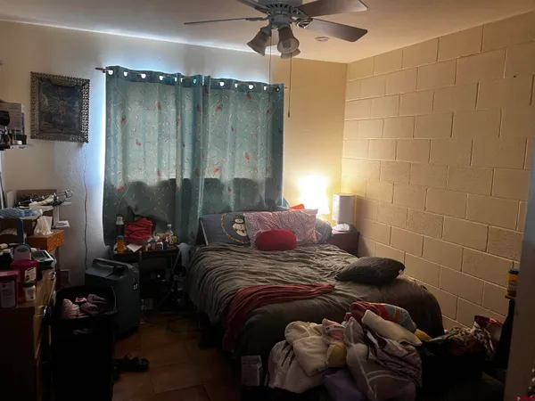 a bedroom with a bed and a chandelier