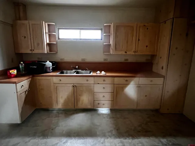 a kitchen with a stove a sink and a microwave