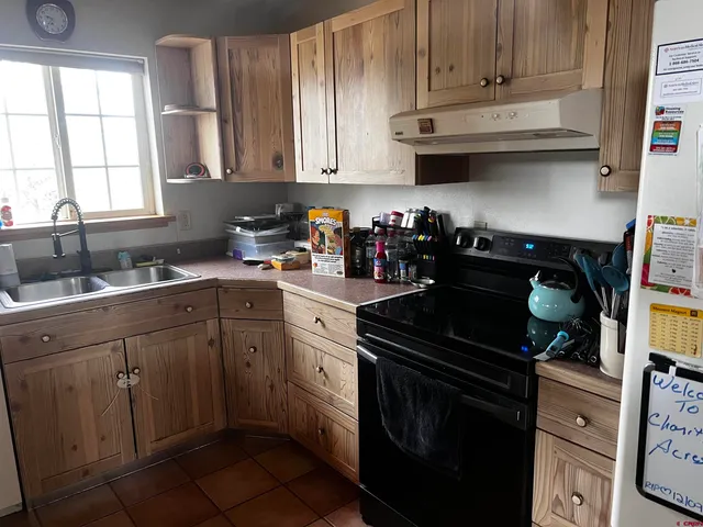 a kitchen with stainless steel appliances granite countertop a sink stove and cabinets