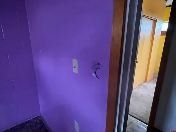 a room with furniture a air conditioner vent and a window