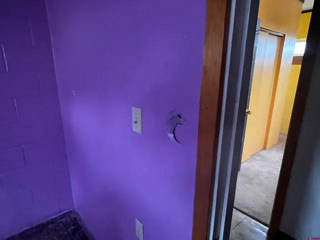 a room with furniture a air conditioner vent and a window