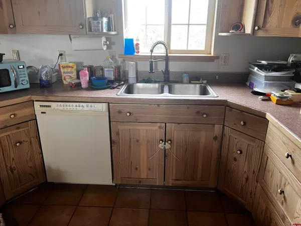a kitchen with a sink window and cabinets