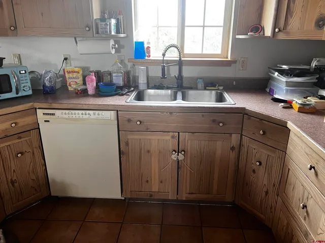 a kitchen with a sink window and cabinets