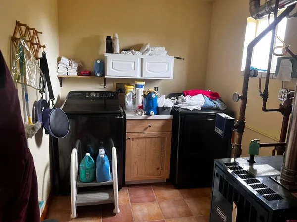 a kitchen with a refrigerator and a stove