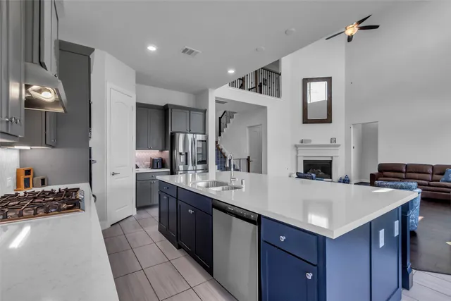 a kitchen with a stove a sink and a refrigerator