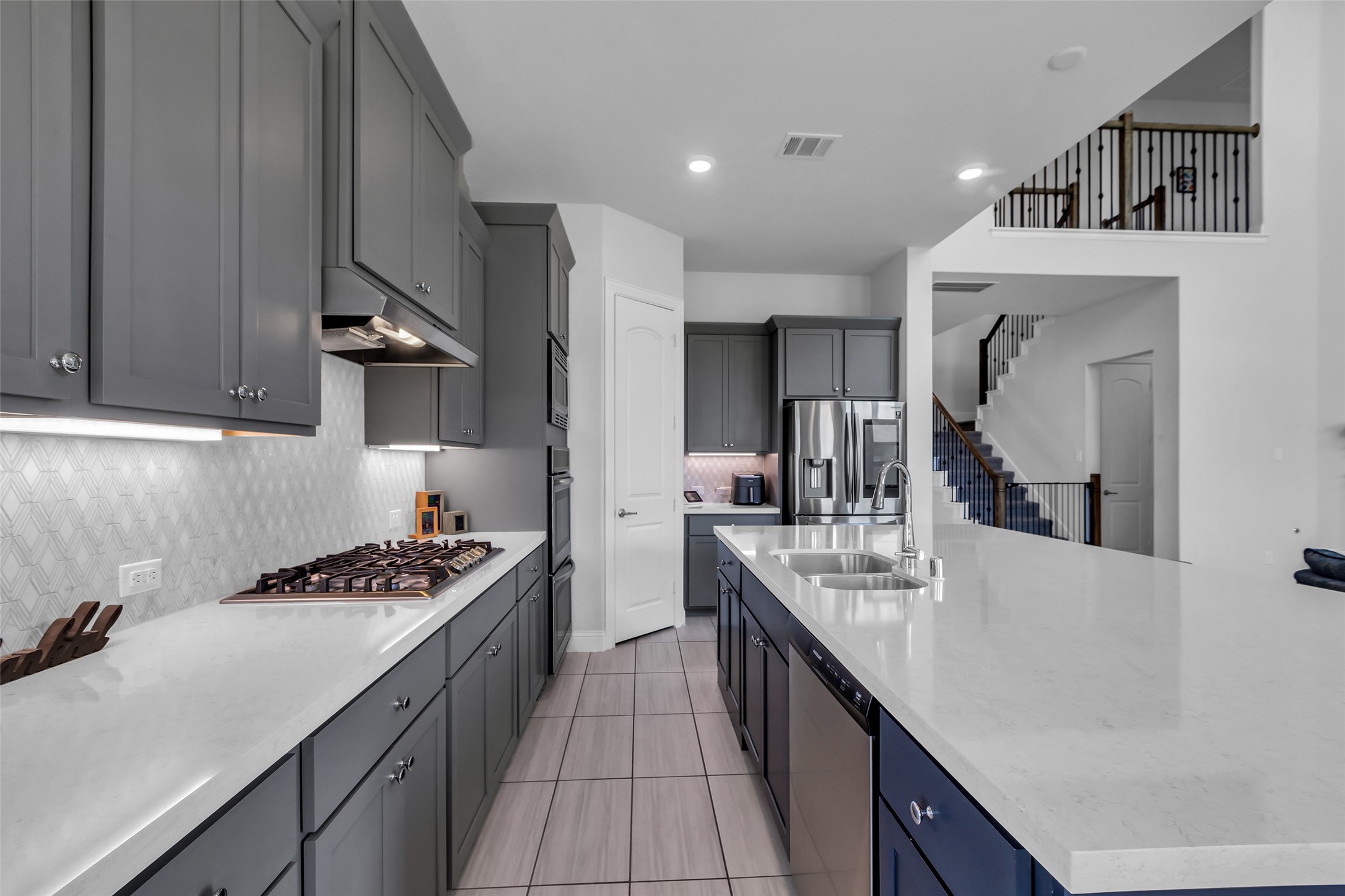 423 Round Top Street Webster, TX 77598 - Photo 18 of 49 a kitchen with kitchen island stainless steel appliances a sink stove and cabinets