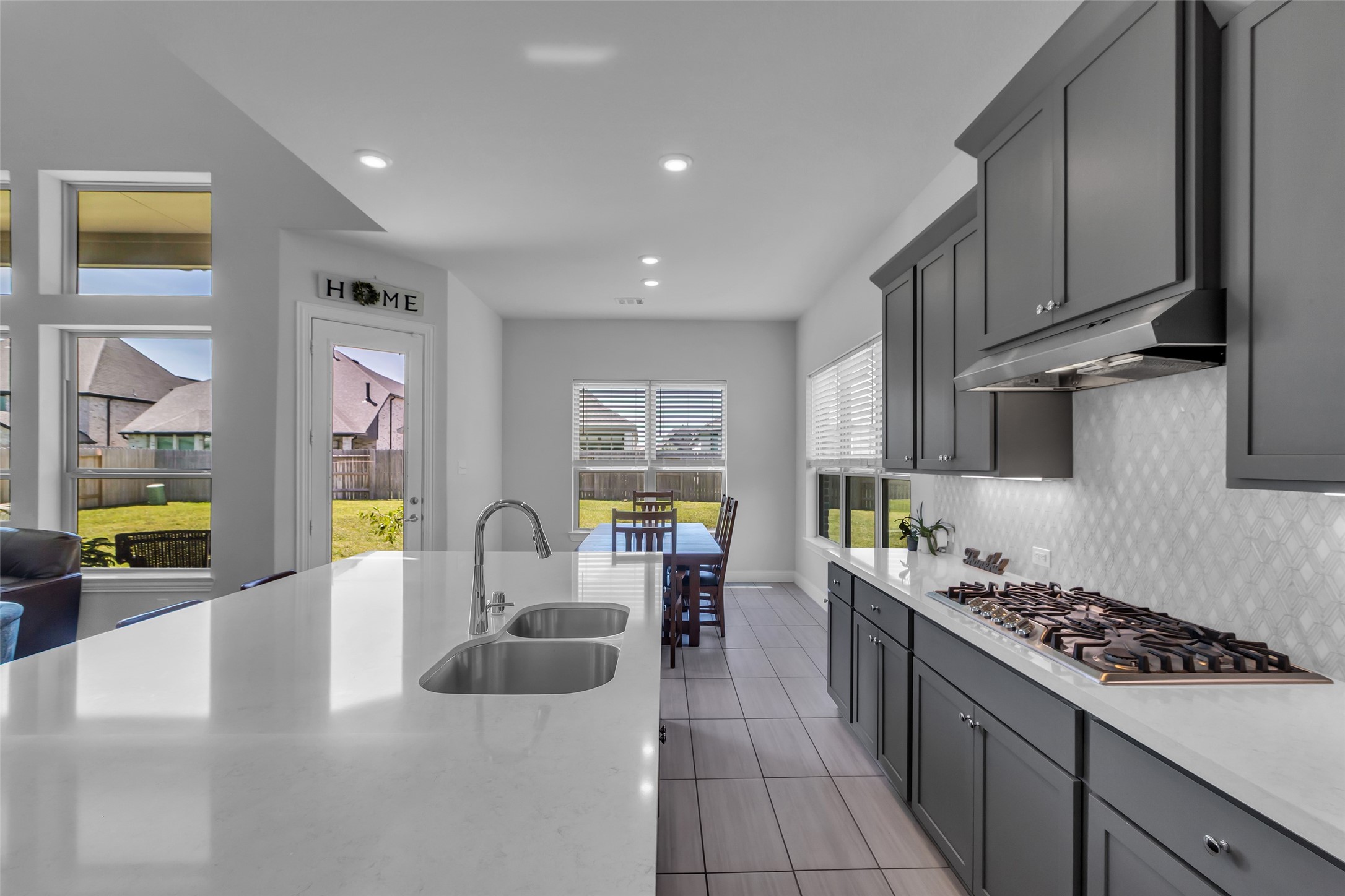423 Round Top Street Webster, TX 77598 - Photo 19 of 49 a kitchen with stainless steel appliances granite countertop a sink a stove and a refrigerator