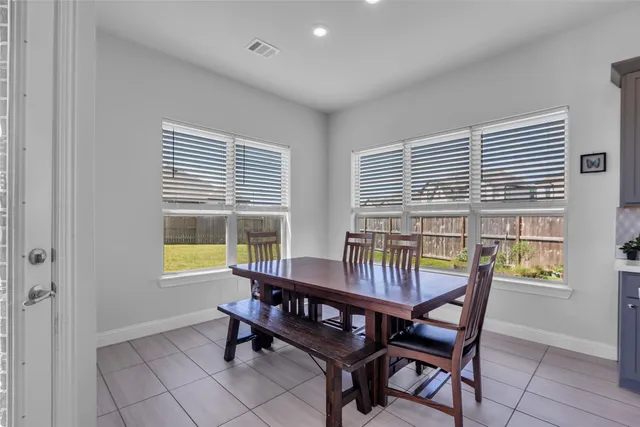 a dining room with furniture and window
