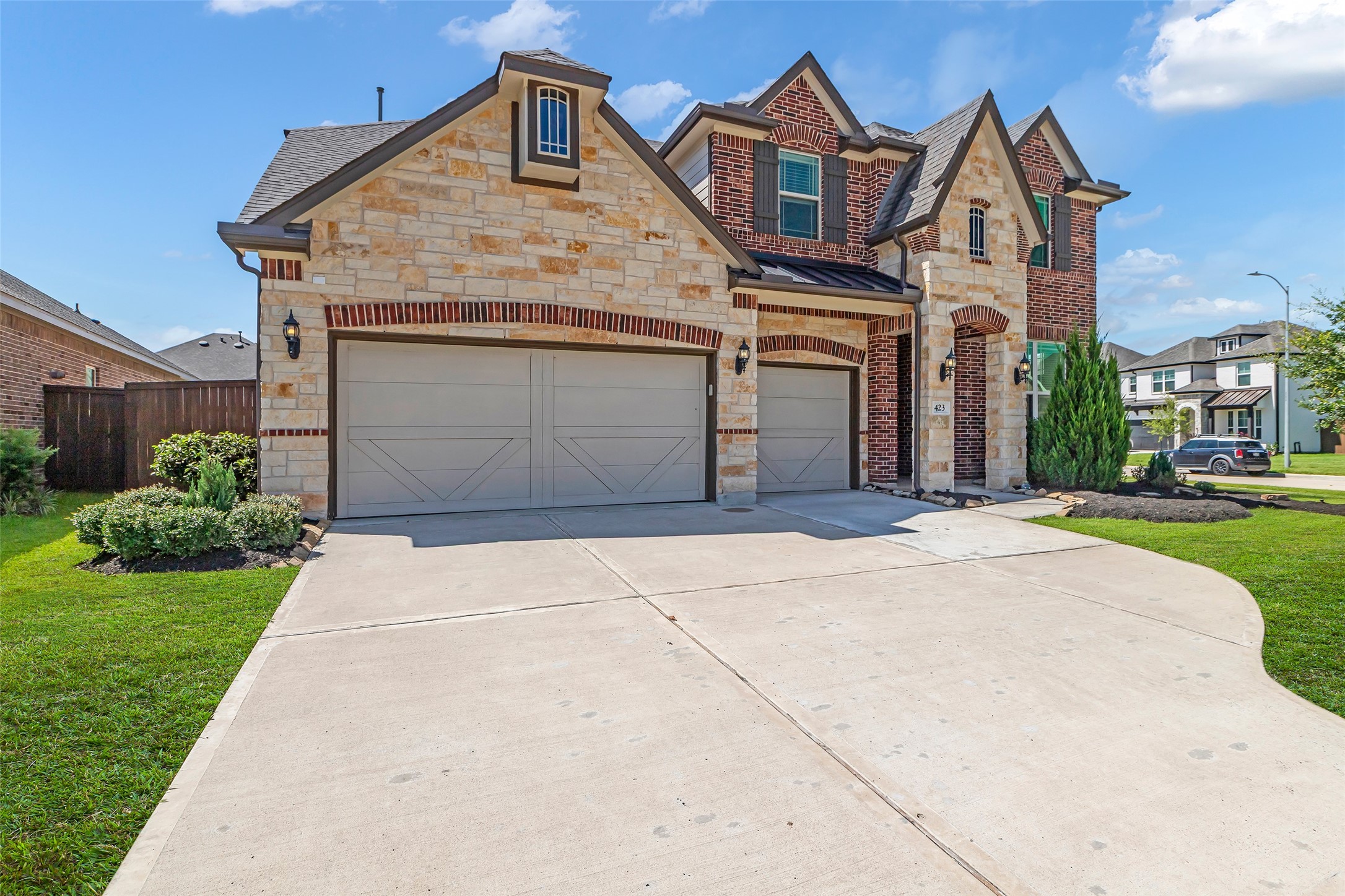 423 Round Top Street Webster, TX 77598 - Photo 2 of 49 a front view of a house with a garden and garage