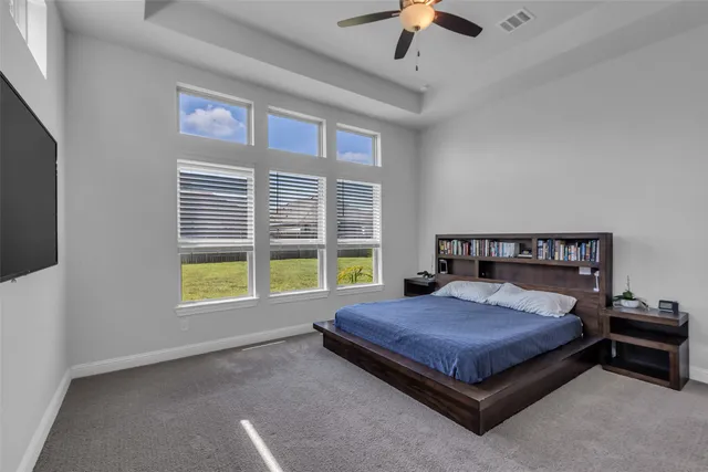 a large bed sitting in a room next to a window