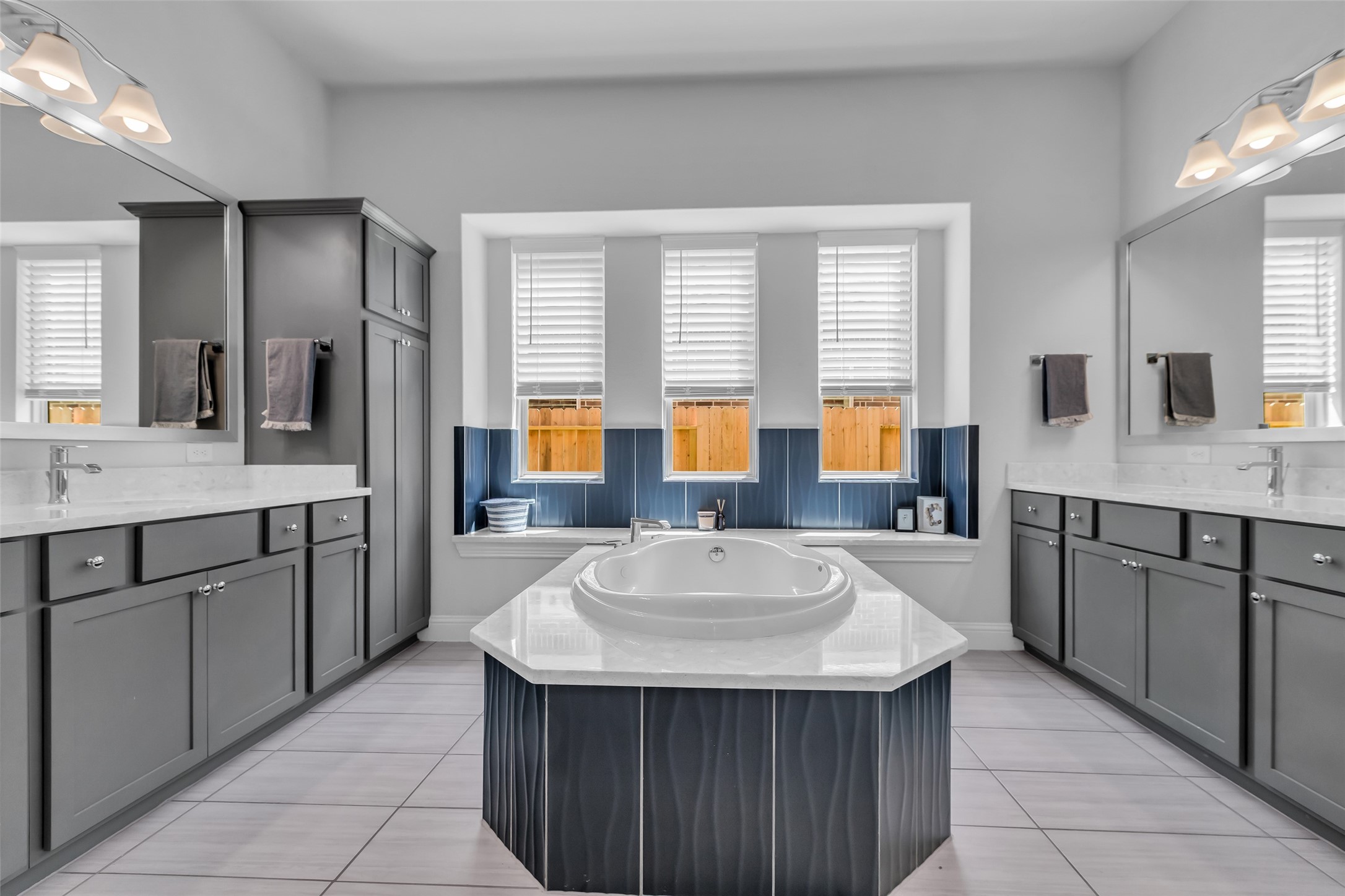 423 Round Top Street Webster, TX 77598 - Photo 24 of 49 a bathroom with a sink double vanity granite tub shower and a mirror