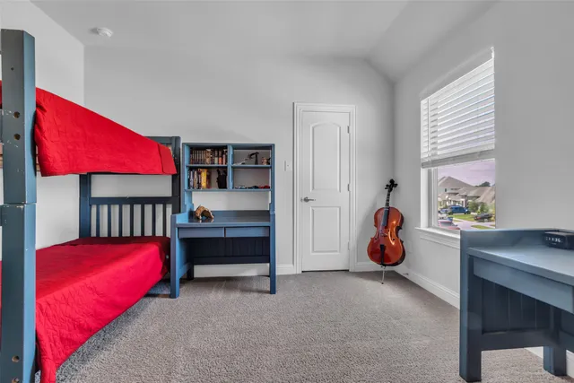 a bedroom with furniture and a window