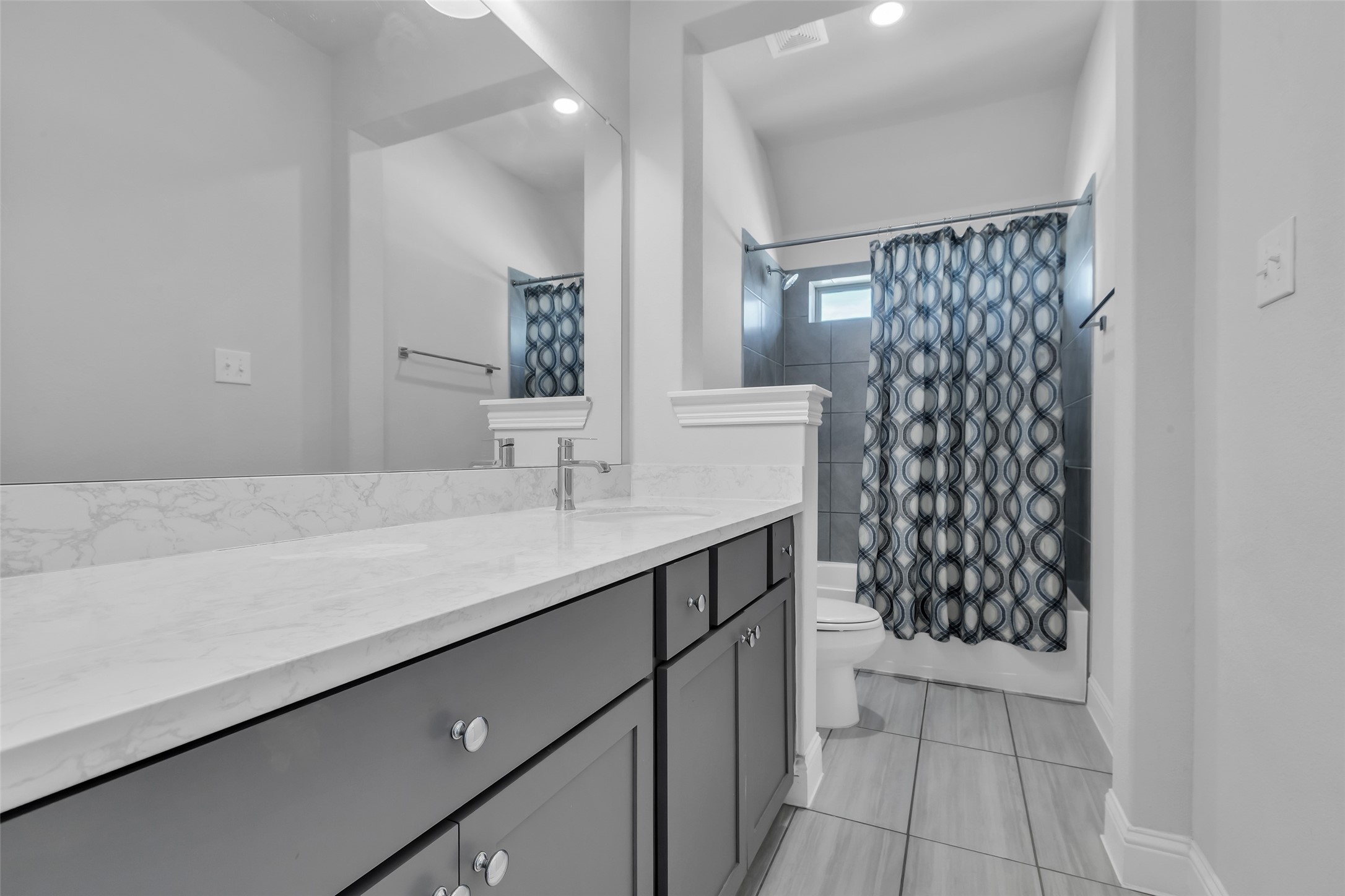 423 Round Top Street Webster, TX 77598 - Photo 32 of 49 a bathroom with a double vanity sink a toilet and a mirror