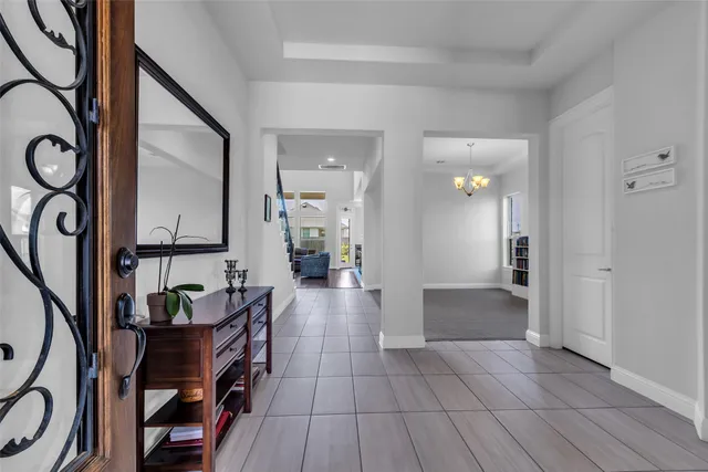 a view of a hallway to a livingroom with furniture and wooden floor