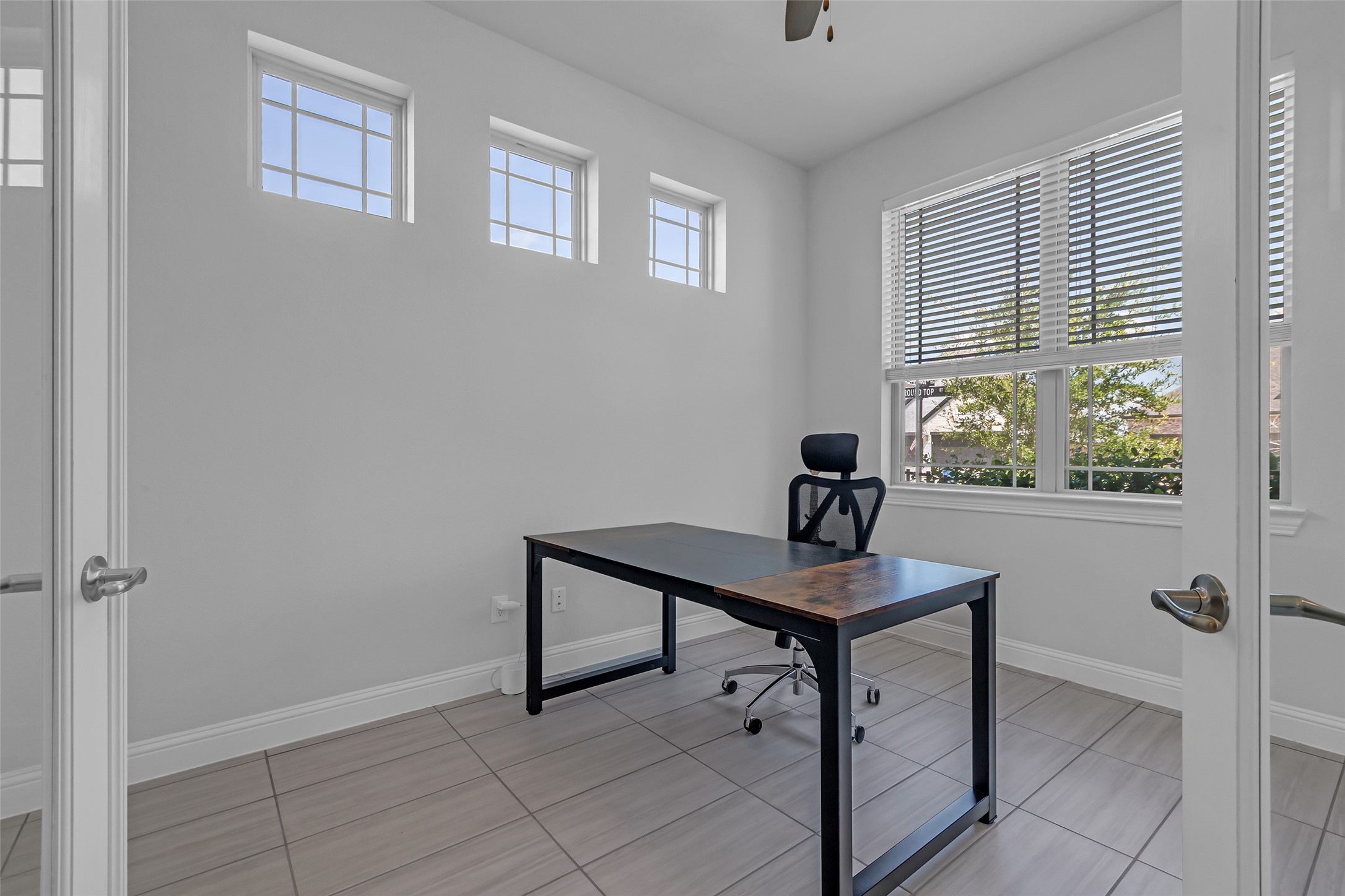 423 Round Top Street Webster, TX 77598 - Photo 6 of 49 a view of a workspace with furniture and a window
