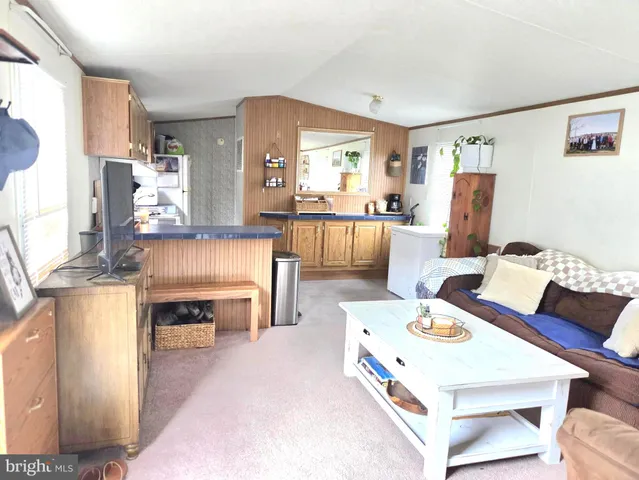 a large kitchen with a table chairs and refrigerator