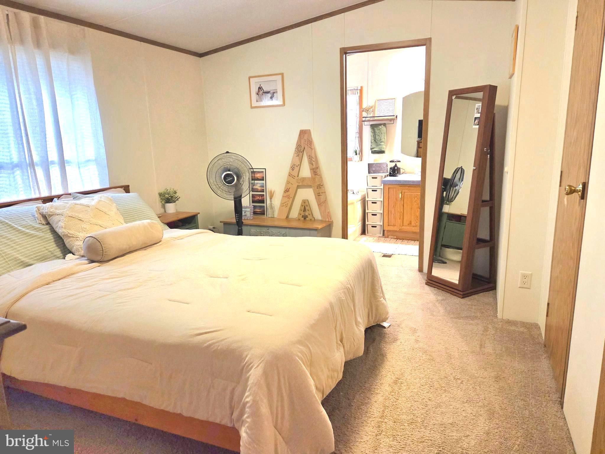 2614 Brian Circle Cambridge, MD 21613 - Photo 6 of 10 a bedroom with a bed and a large mirror