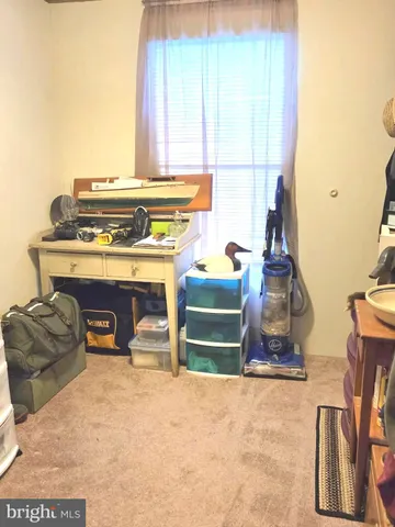 a view of a room with furniture and a window